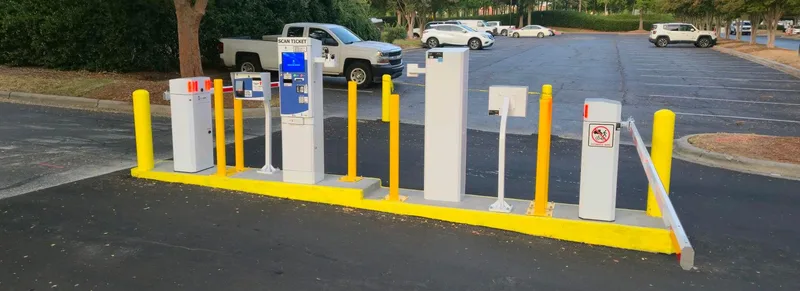 Parking BOXX full exit lane system — Exit BOXX terminal, access control pedestal, and barrier gate at a hotel parking facility