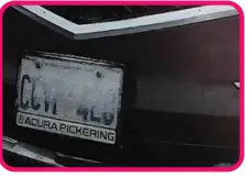 License plate partially obscured after light snow accumulation