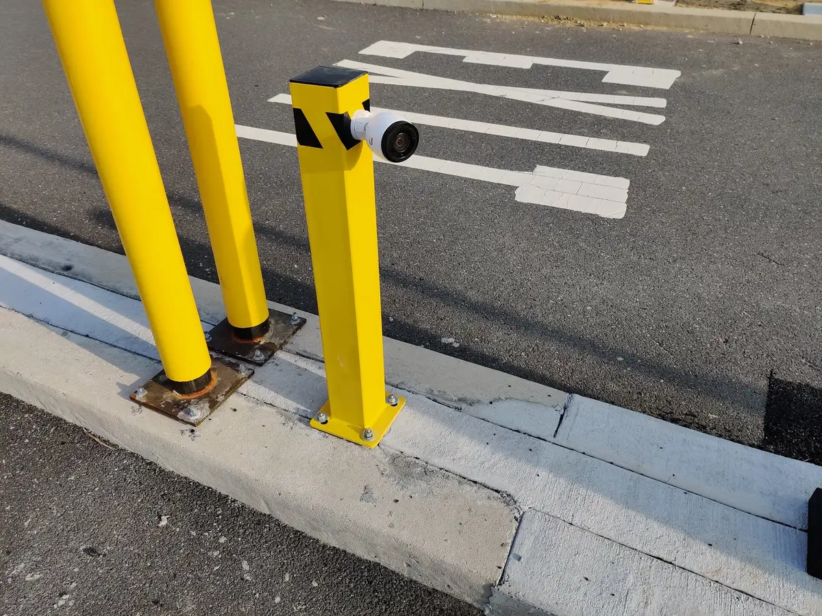 An ALPR camera mounted on a bollard at a parking facility entrance